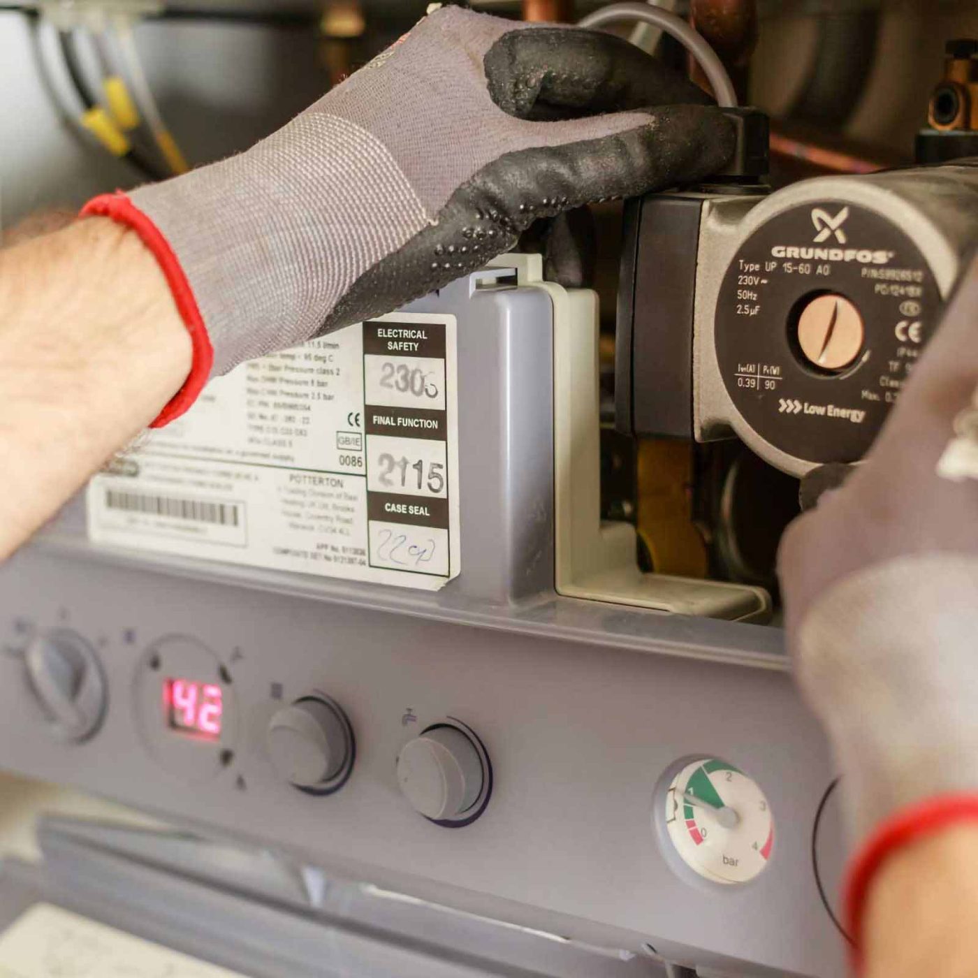 NCCS Group - A heating engineer repairing and installing a boiler.