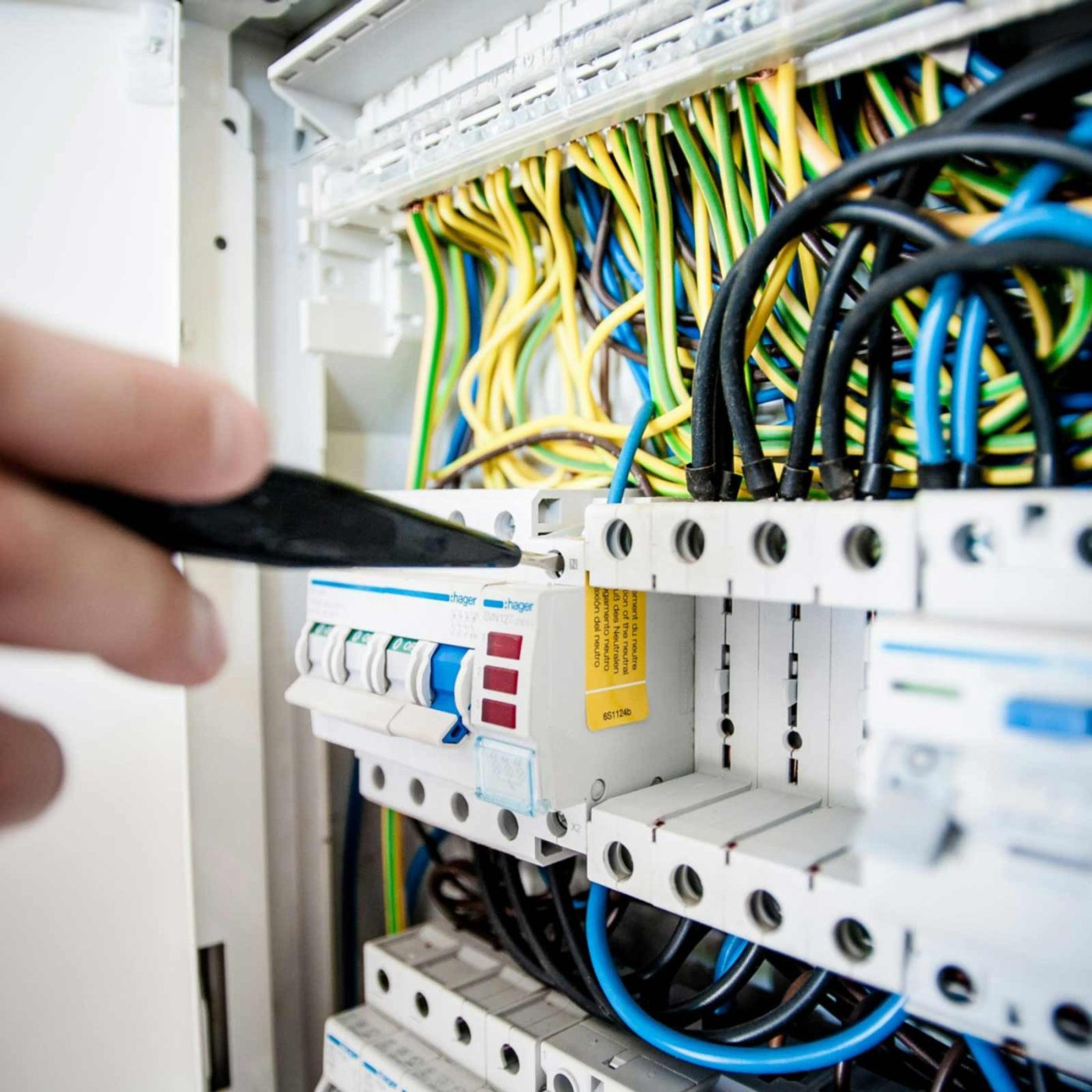 NCCS Group - Engineer using a screwdriver in an electric fusebox.