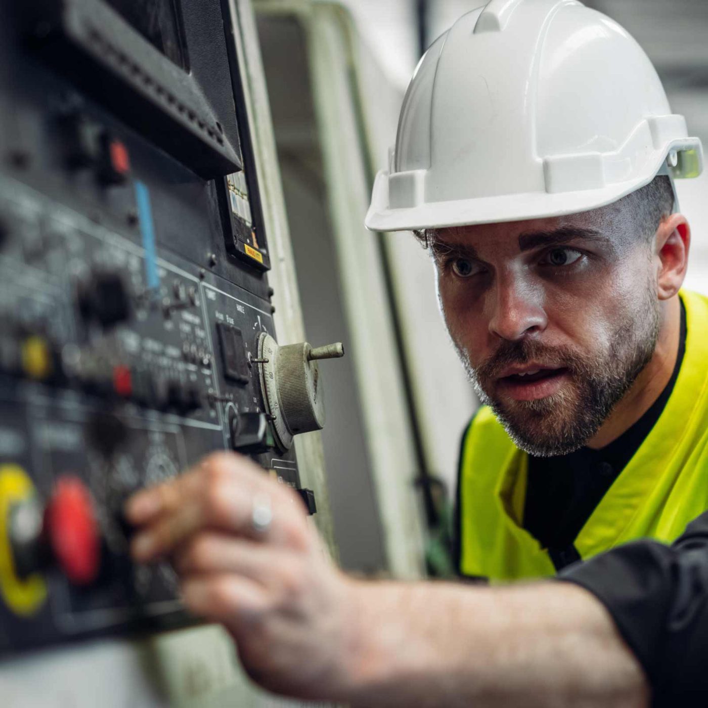 NCCS Group - A heating engineer working controls on a heating and water control panel.